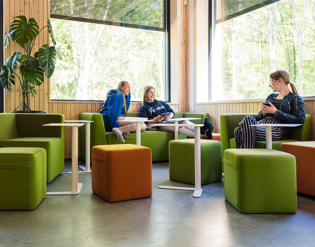 Students at Drøbak Montessori School sitting on Martela's Bit sofas and stools