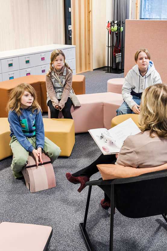 A teacher reading a book to pupils