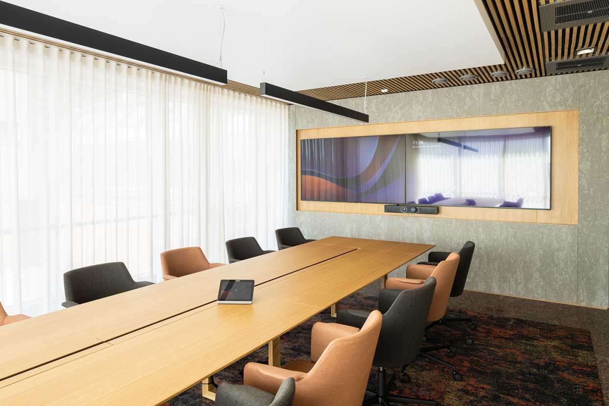 A long conference table and chairs in the conference room