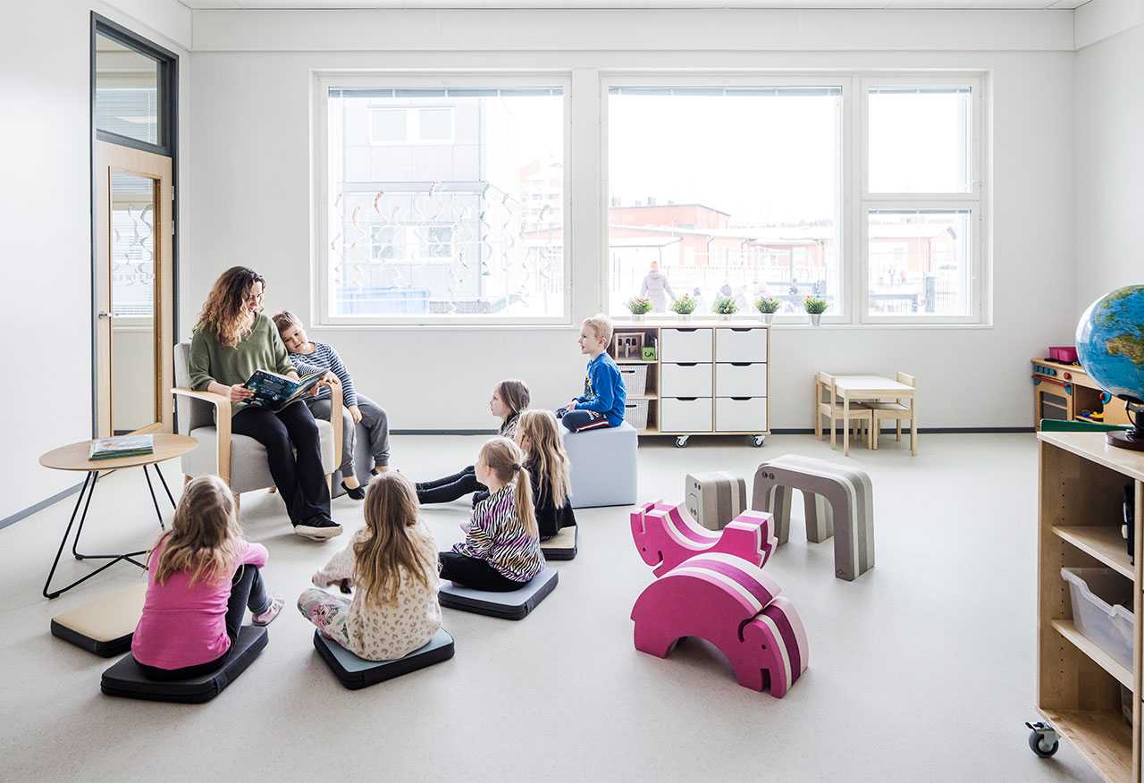 Teacher reading a book to preschoolers