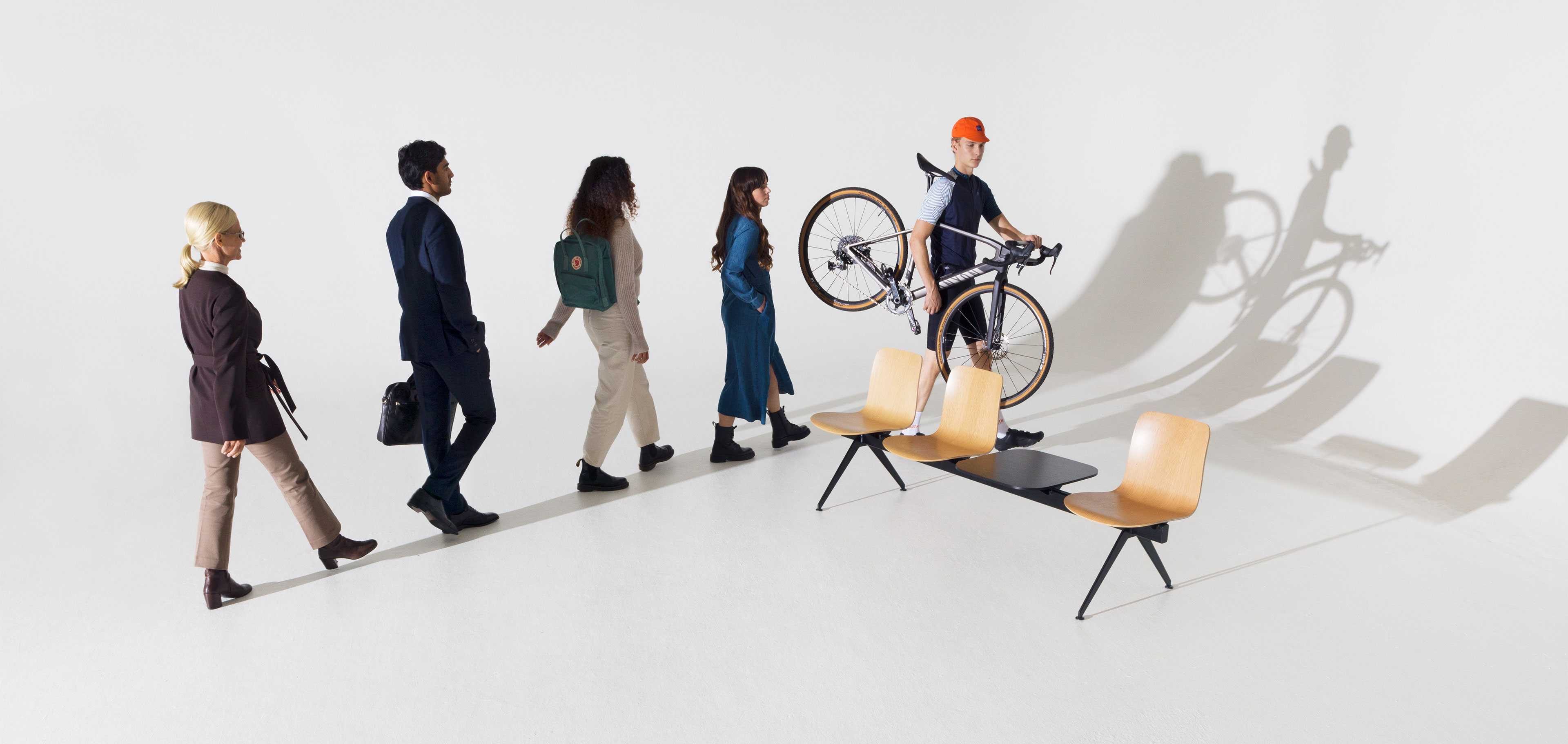 People walking in a line around Sola Beam chair