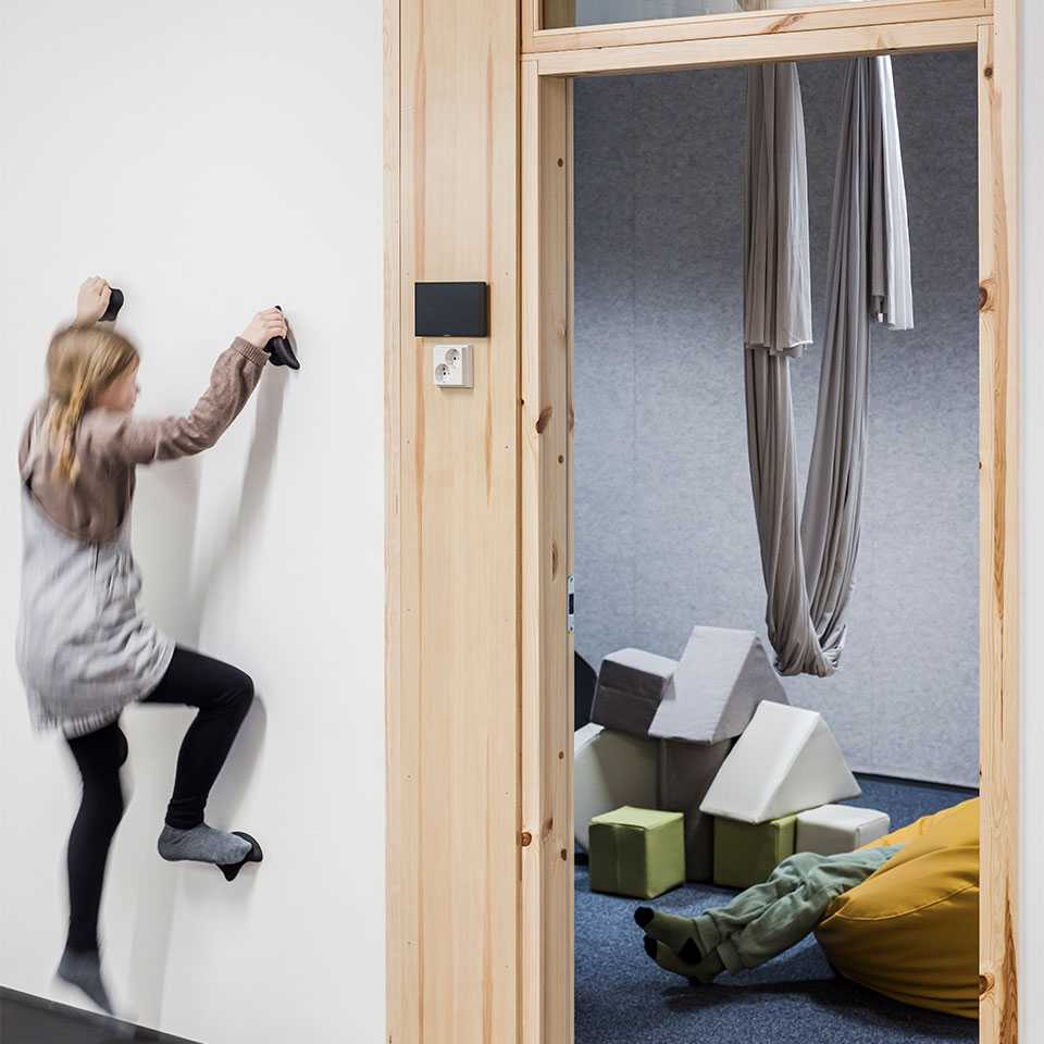 A pupil climbing a wall in the school corridor